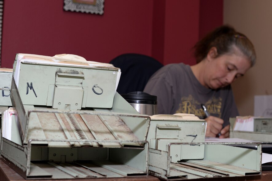 Kim Thompson, 2nd Communications Squadron assistant postal center manager, alphabetizes mail at Barksdale Air Force Base, La., Sept. 3, 2015. Postal center employees must sort through piles of mail to ensure it is delivered to the correct person. (U.S. Air Force photo/Senior Airman Amanda Morris)