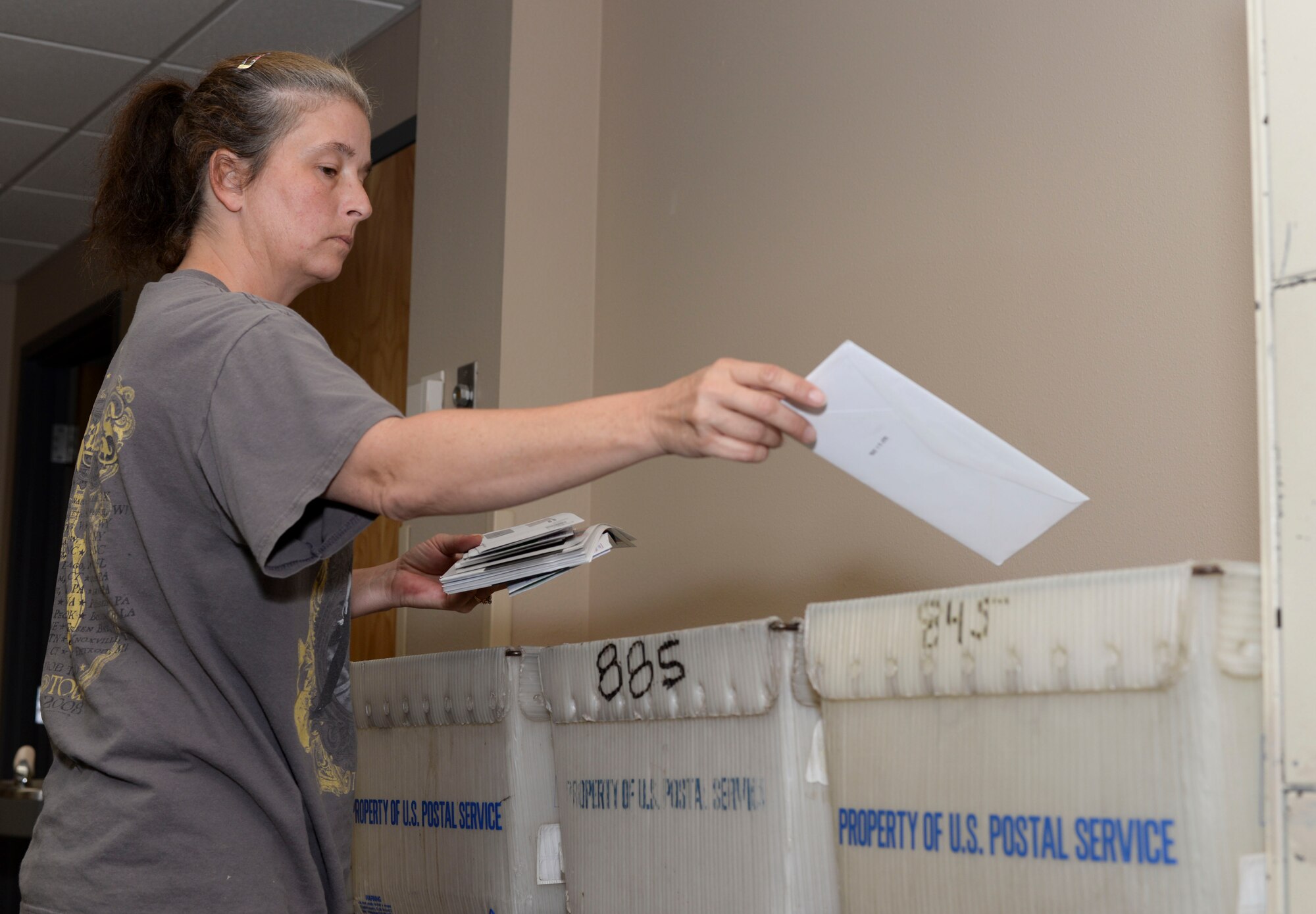 Kim Thompson, 2nd Communications Squadron assistant postal center manager, separates mail before it is distributed to dormitory mail boxes at Barksdale Air Force Base, La., Sept. 3, 2015. The postal center receives, separates and distributes mail to Airmen living in the dormitories. (U.S. Air Force photo/Senior Airman Amanda Morris) 