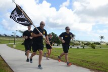 Members of the U.S. Air Force Office of Special Investigations Detachment 602 run during the Prisoner of War and Missing in Action vigil run Sept. 18, 2015 at Andersen Air Force Base, Guam. Airmen from multiple squadrons ran in one-hour shifts during the 24 hour run which began Sept 17. (U.S. Air Force photo by Airman 1st Class Arielle Vasquez/Released)