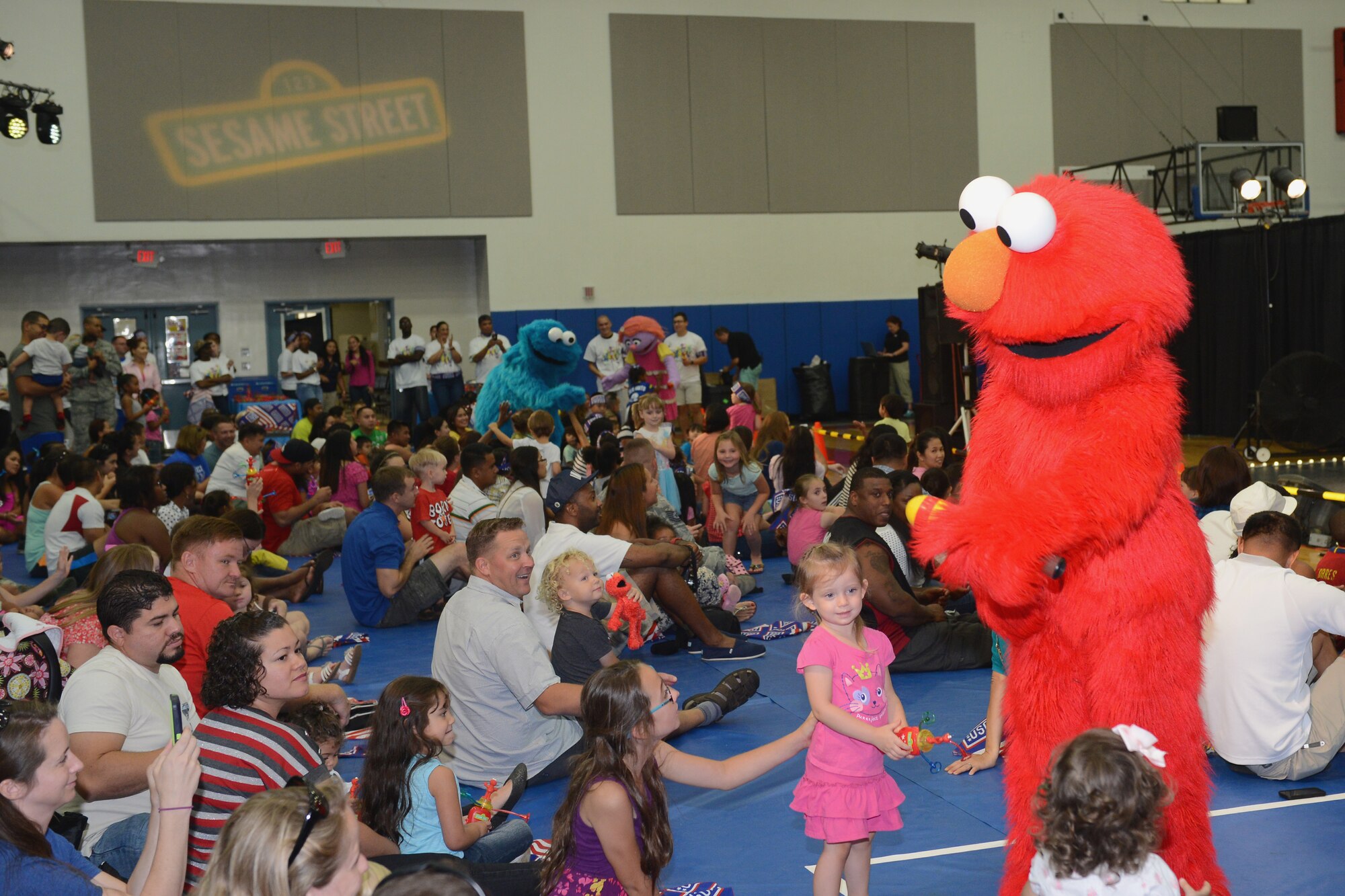 Sesame Street characters interact with military families during the Sesame Street United Service Organizations Experience for Military Families tour Sept. 19, 2015, on Andersen Air Force Base, Guam. The cast is scheduled to perform at more than 100 shows at 45 military bases in 9 countries this year.  (U.S. Air Force photo by Airman 1st Class Arielle Vasquez/Released)