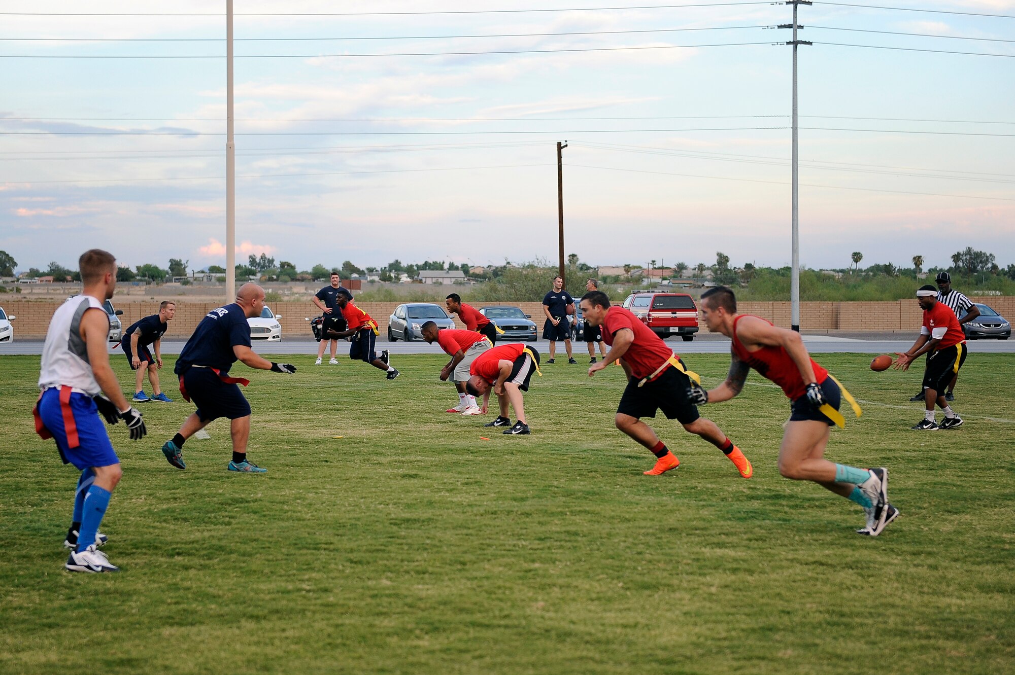 The 56th Medical Group snaps the ball Sept. 8, 2015, against the 56th Civil Engineering Squadron at Luke Air Force Base, Ariz. The final score was 21-6 in favor of the 56th MDG team. (U.S. Air Force photo by Airman Pedro Mota)