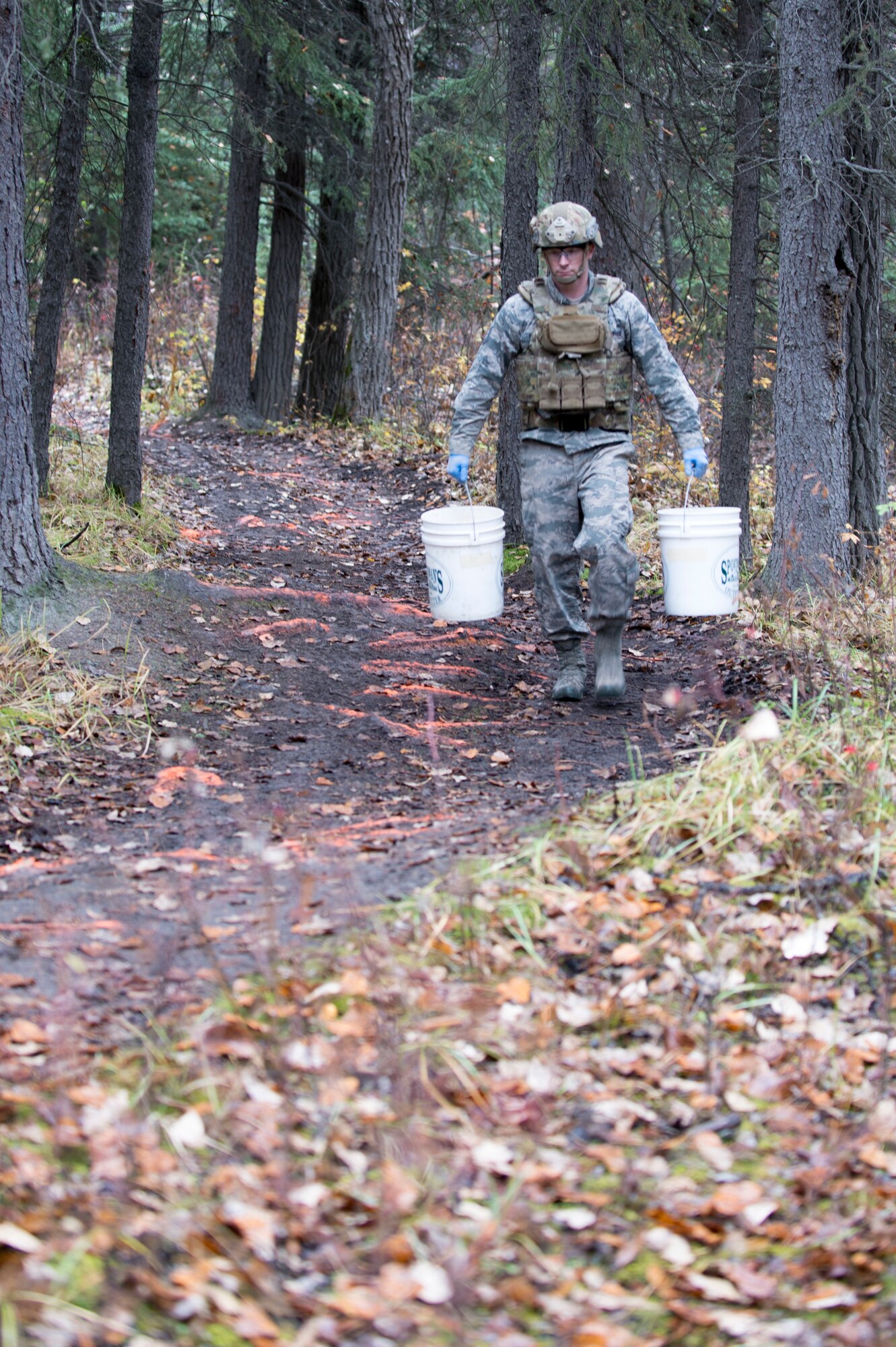 Master Sgt. Harold Horton, an Eielson Air Force Base, Alaska, 354th Civil Engineer Squadron explosive ordinance disposal (EOD) technician, carries two of four buckets containing 65 sticks deteriorating dynamite from a garage in Delta Junction, Alaska, to the dry Tanana River bed for disposal Sept. 20, 2015. Eielson’s EOD technicians, which form the smallest operational flight in the Air Force, respond around the northern part of the state covering an area of responsibility larger than the state of Texas when local civil authorities call for the mutual aid. (U.S. Air Force photo by Staff Sgt. Shawn Nickel/Released)