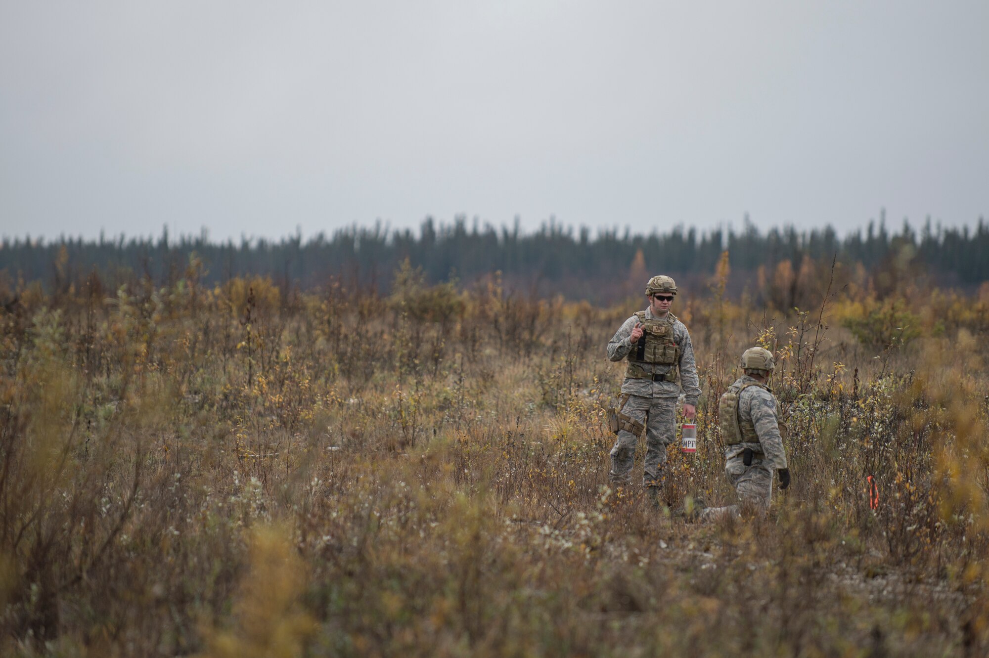 Airman 1st Class Dillon Babb (left) and Tech. Sgt. Michael Alexander II (right), from Eielson Air Force Base, Alaska, 354th Civil Engineer Squadron explosive ordinance disposal (EOD) technicians, prepare to blow up one of four buckets containing 65 sticks deteriorating dynamite removed from a garage in Delta Junction, Alaska, Sept. 20, 2015. Eielson’s EOD technicians, which form the smallest operational flight in the Air Force, respond around the northern part of the state covering an area of responsibility larger than the state of Texas when local civil authorities call for the mutual aid. (U.S. Air Force photo by Staff Sgt. Shawn Nickel/Released)