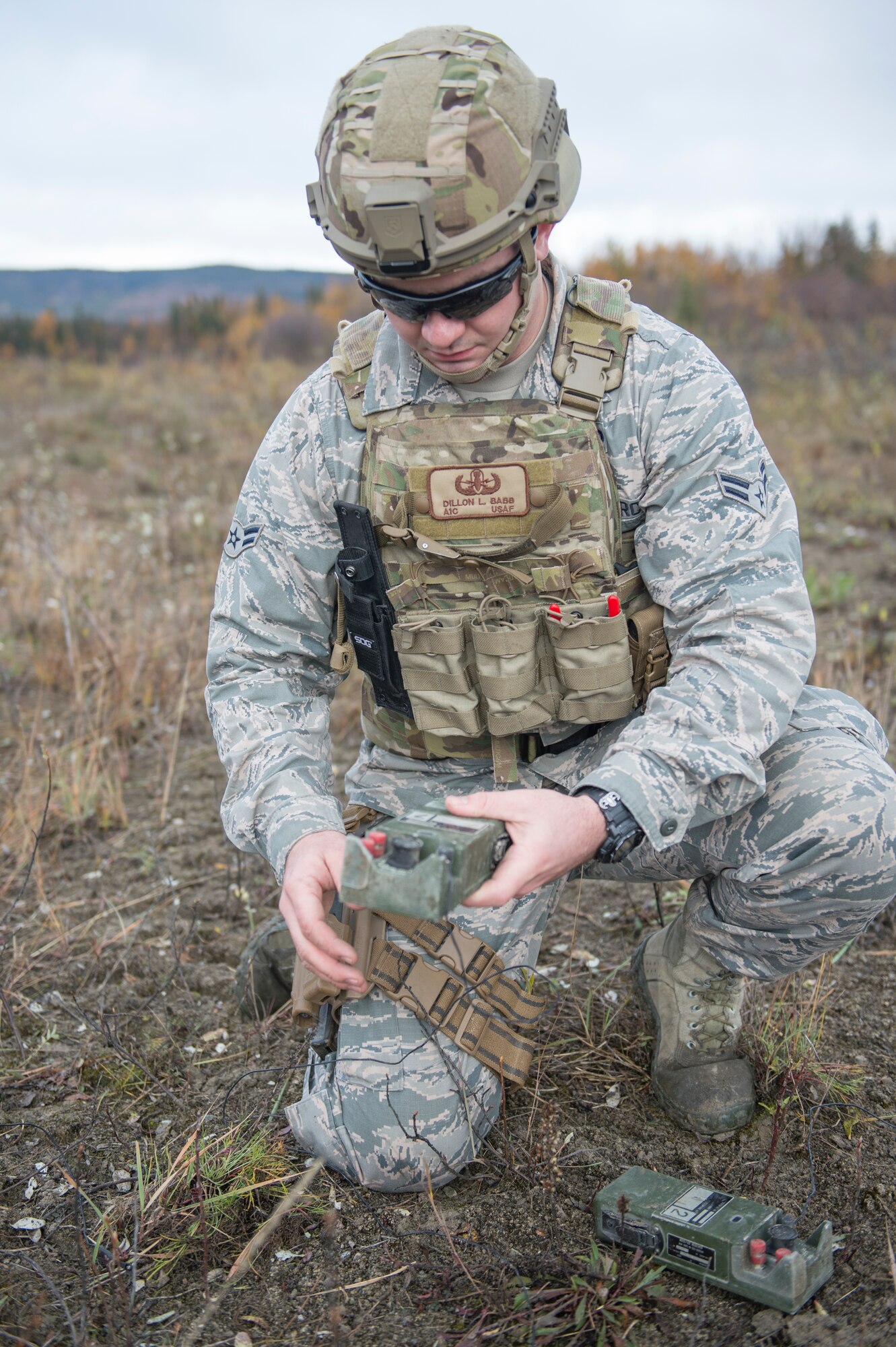 Airman 1st Class Dillon Babb an Eielson Air Force Base, Alaska, 354th Civil Engineer Squadron explosive ordinance disposal (EOD) technician, sets a charge to blow up dynamite removed from a garage in Delta Junction, Alaska, Sept. 20, 2015. The operation was being conducted at the request of local authorities. (U.S. Air Force photo by Staff Sgt. Shawn Nickel/Released)