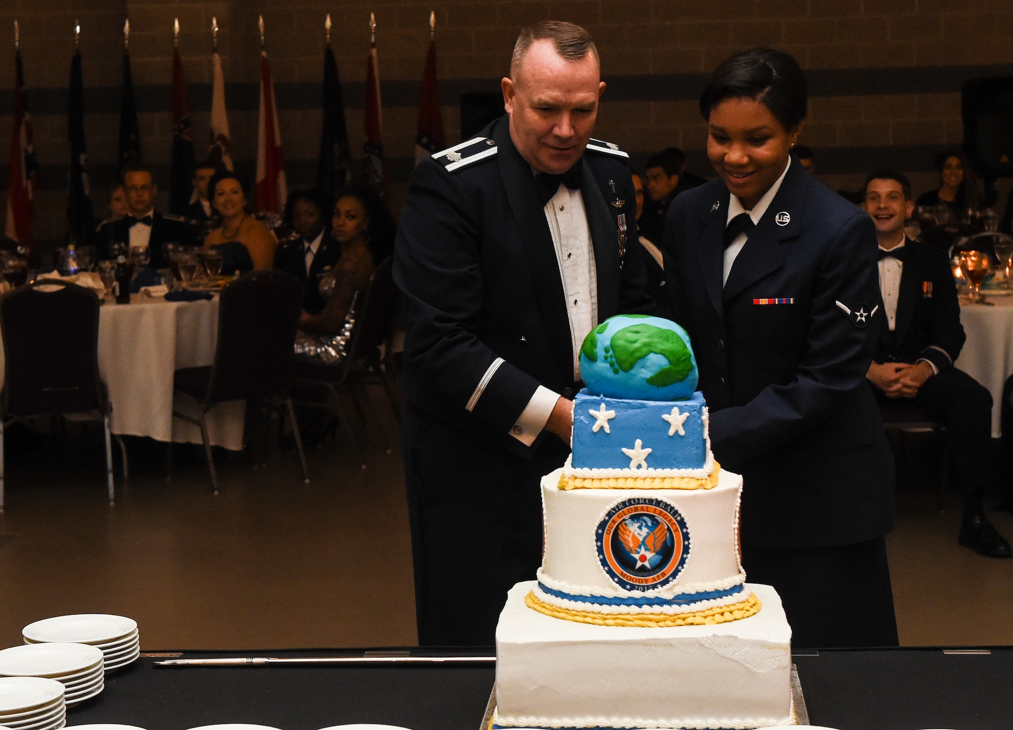 U.S. Air Force Chaplain (Lt. Col.) Kim Bowen, 23d Wing, and Airman Kristin Terry, 23d Medical Operations Squadron mental health technician, cut the cake at the Air Force Ball Sept. 19, 2015, in Valdosta, Ga. It is a long standing tradition for the oldest and youngest active duty Airmen to cut the first slice of cake. (U.S. Air Force photo by Senior Airman Ceaira Tinsley/Released)