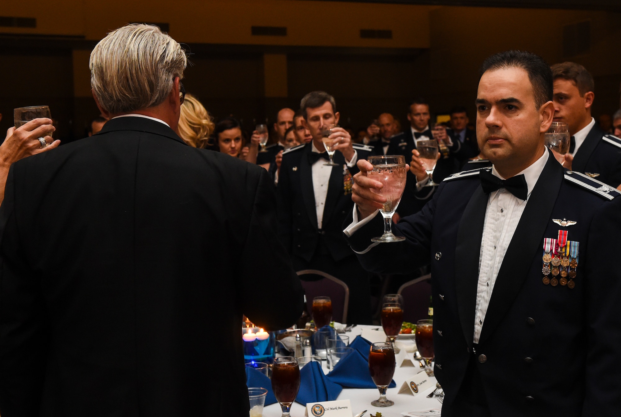 U.S Air Force Col. Mark Barrera, 23d Wing vice commander, raises his glass during a toast at the Air Force Ball Sept. 19, 2015, in Valdosta, Ga. Guests in attendance toasted to the approximately 83,000 prisoners of war and missing in action, past and present, who have yet to return home. (U.S. Air Force photo by Senior Airman Ceaira Tinsley/Released)