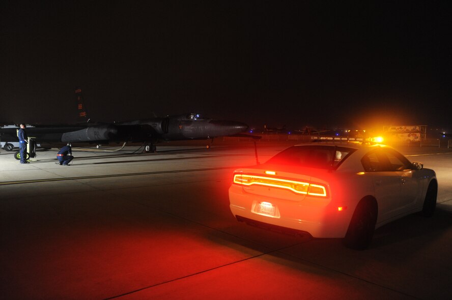 A mobile chase car waits for the take-off a U-2 "Dragon Lady" during the early morning of Sep. 19, 2015, at Joint Base Andrews, Maryland. Mobile chase cars accelerate to speeds more than 100 mph to guide U-2 aircraft during takeoffs and landings. (U.S. Air Force photo by Senior Airman Bobby Cummings/Released) 