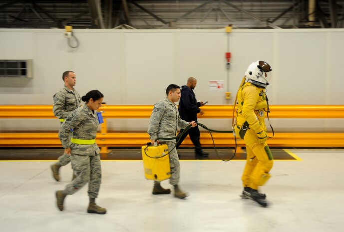 Airmen from the 9th Physiological Support Squadron, escort Capt. Travis, 99th Reconnaissance Squadron U-2 pilot, to his U-2 Dragon Lady aircraft Sep. 19, 2015, at Joint Base Andrews, Maryland. The full-pressure serves as a precautionary measure if the cockpit of a U-2 Dragon Lady were to decompress at high altitudes. (U.S. Air Force photo by Senior Airman Bobby Cummings)