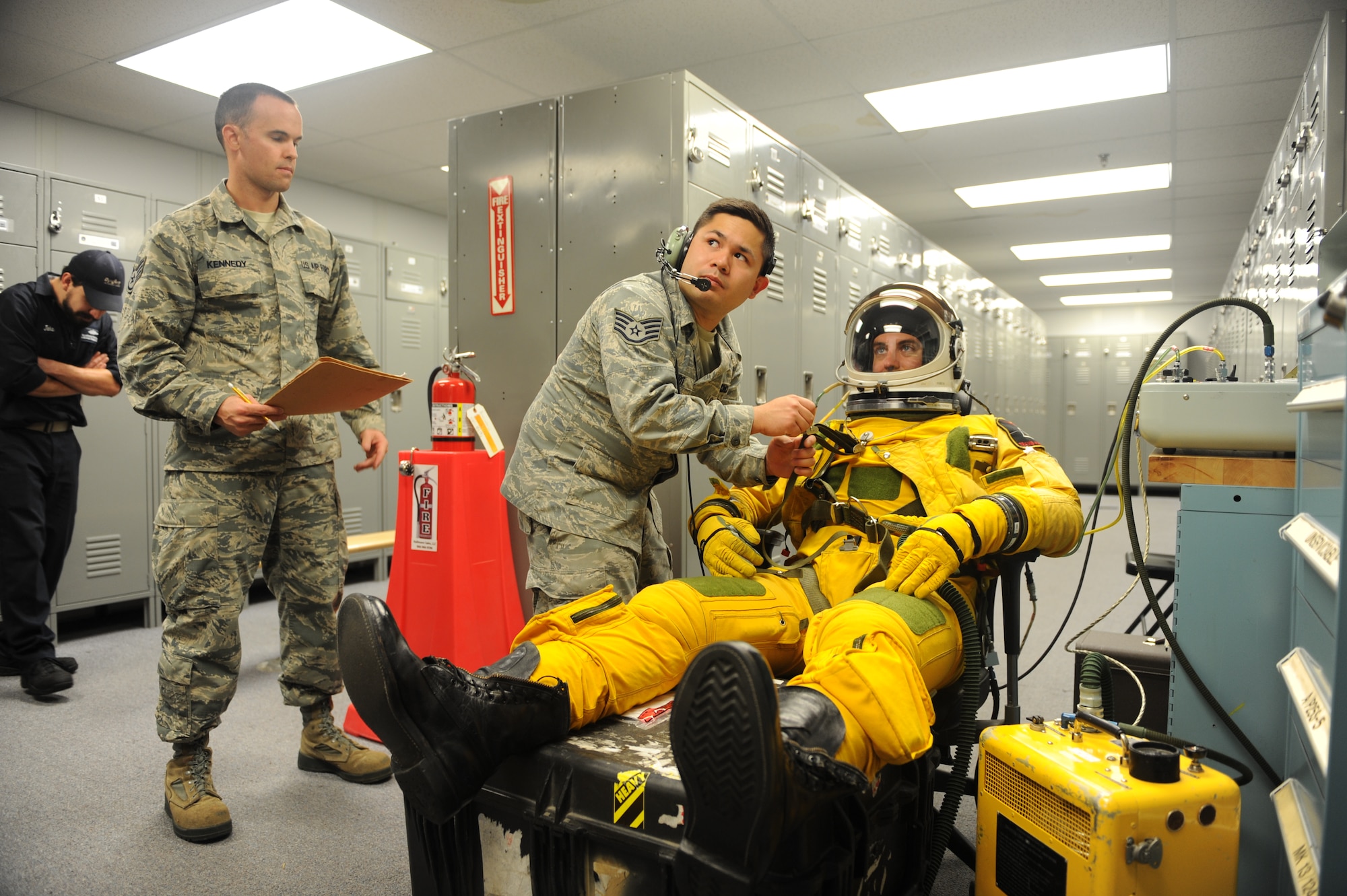 Staff Sgt. Timothy Dayrit (center), and Staff Sgt. Joseph Kennedy (left), 9th Physiological Support Squadron full-pressure suit technicians perform pre-flight full-pressure suit maintenance for Capt. Travis, 99th Reconnaissance Squadron U-2 pilot, Sep. 19, 2015, at Joint Base Andrews, Maryland. The full-pressure is worn by U-2 Dragon Lady pilots who frequently fly at the edge of space. (U.S. Air Force photo by Senior Airman Bobby Cummings)