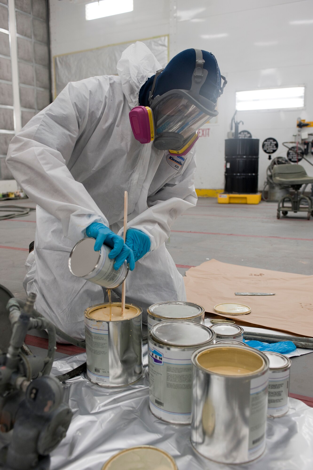 Jamaul Cherry, 57th Maintenance Group Corrosion shop aircraft painter, prepares primer to be sprayed onto an F-16 Fighting Falcon inside a temperature-controlled building on Nellis Air Force Base, Nev., Sept. 9, 2015. Before spraying an aircraft, painters ensure parts that don’t require paint or can’t be painted are masked off. (U.S. Air Force photo by Airman 1st Class Mikaley Kline)