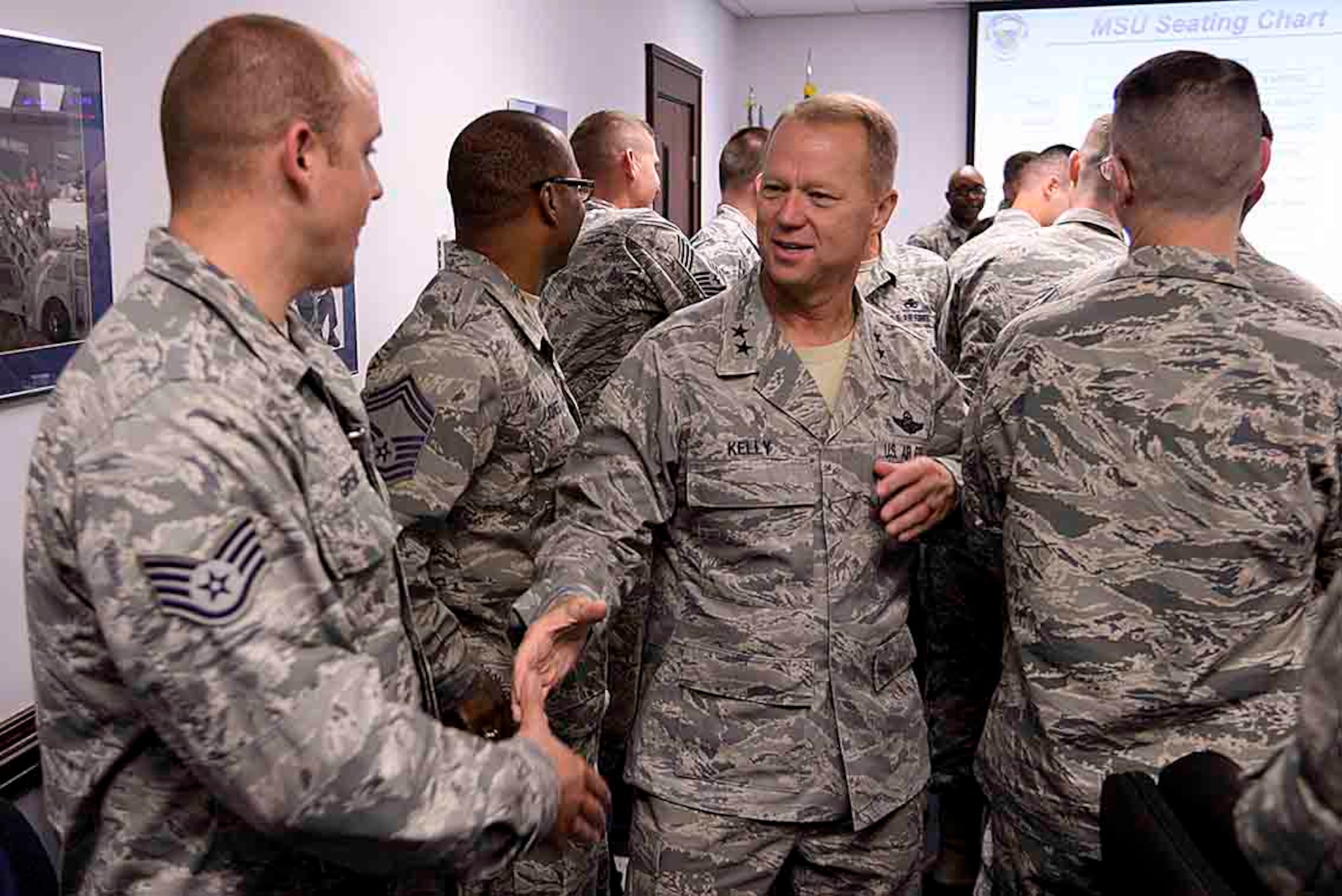 Maj. Gen. Mark Kelly, 9th Air Force commander, introduces himself to several members of the 4th Maintenance Group during a maintenance stand-up, Sept 14, 2015, at Seymour Johnson Air Force Base, North Carolina. Due to the 24/7 tempo of maintenance operations, the 4th MXG utilizes stand-ups to pass information from the night prior to the group and squadron commanders, and discuss any incidents which may have occurred. (U.S. Air Force photo/Senior Airman Brittain Crolley)