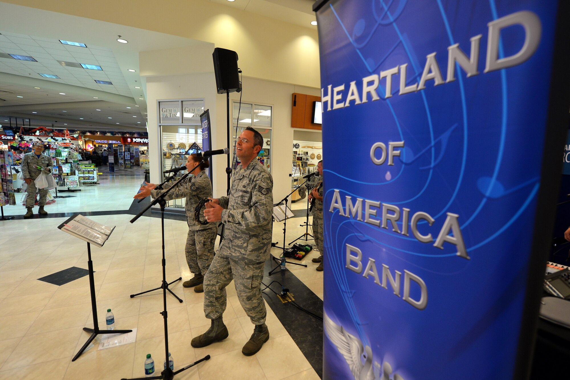 U.S. Air Force Tech. Sgt. Rebecca Packard and Staff Sgt. Geoffrey Fisher, vocalists with the U.S. Air Force Heartland of America Band, perform at the Offutt Exchange in honor of the U.S. Air Force’s 68th birthday on Sept. 18, Offutt Air Force Base, Neb.  The U.S. Air Force Heartland of America Band’s Raptor ensemble is a high energy group playing modern hit music.  (U.S. Air Force photo by Josh Plueger/Released)
