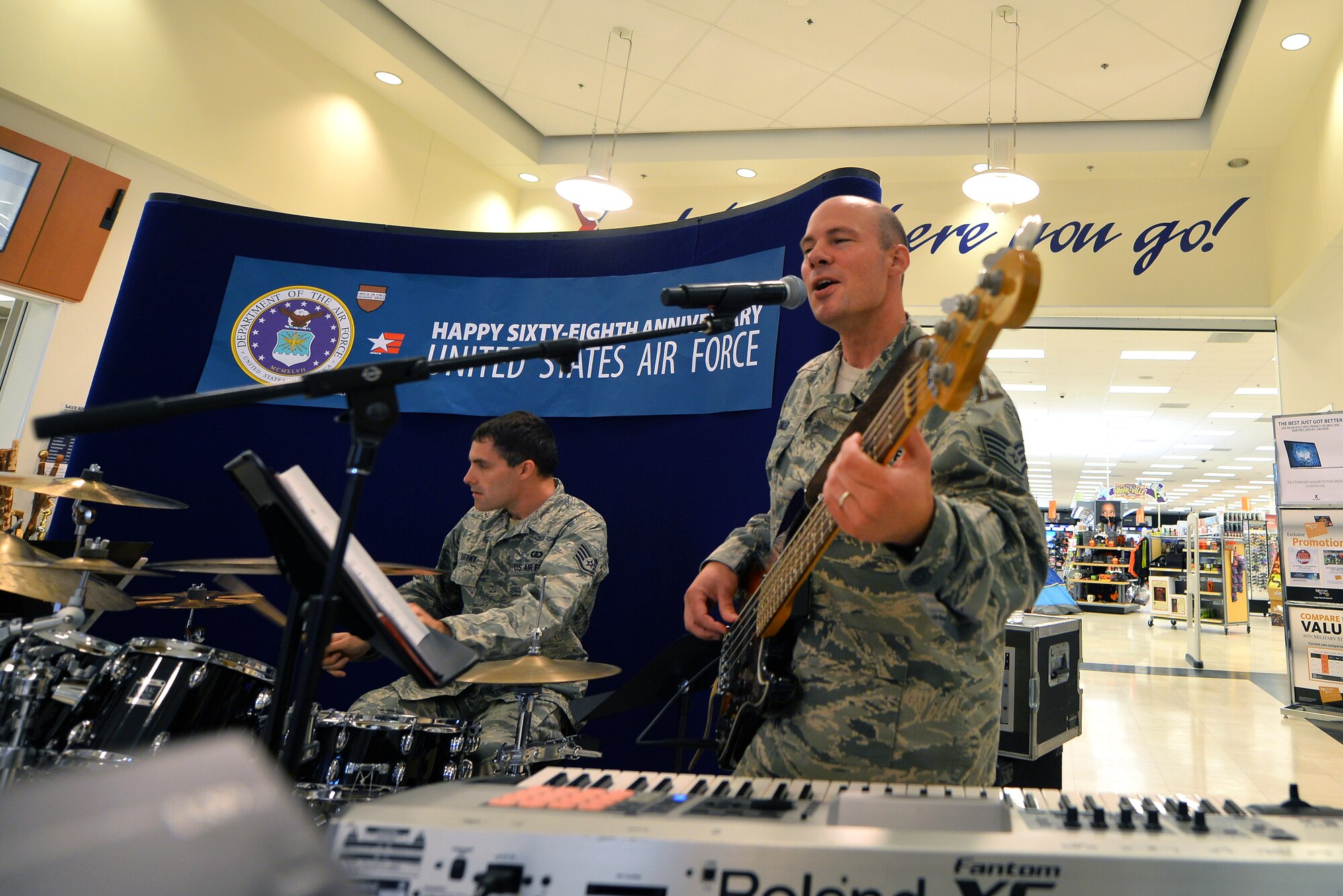 U.S. Air Force Staff Sgt. Anthony Schmaus (guitar) and Ed Zaryky (drums), with the United States Air Force Heartland of America Band, perform at the Offutt Exchange in honor of the U.S. Air Force’s 68th birthday on Sept. 18, Offutt Air Force Base, Neb.  In addition to the free entertainment, hundreds of cupcakes and refreshments were offered to shoppers and the lunchtime crowd.  (U.S. Air Force photo by Josh Plueger/Released)