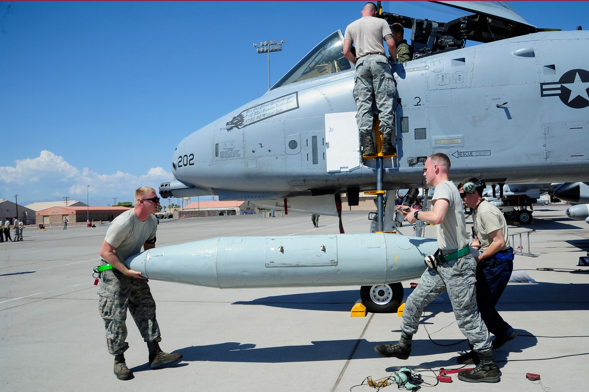 U.S. Airmen from the 355th Maintenance Squadron remove a travel pod from an A-10 Thunderbolt II after the aircraft landed at Nellis Air Force Base, Nev., Sept. 10, 2015. More than 100 personnel and eight A-10s from Davis-Monthan AFB, Ariz., are participating in Green Flag-West 15-10, an advanced, realistic, and relevant air to surface training exercise. (U.S. Air Force photo by Senior Airman Betty R. Chevalier/Released)