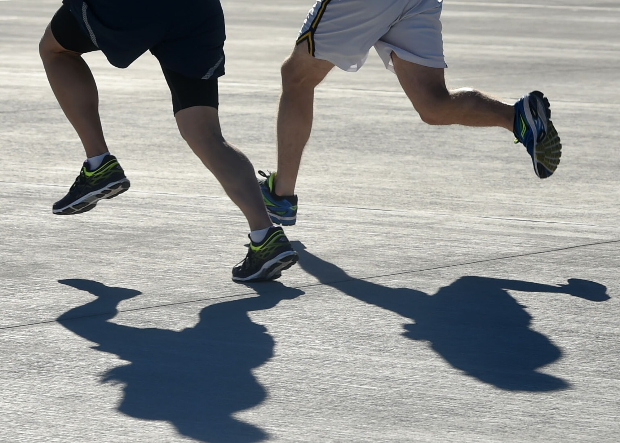 Airmen of the 432nd Wing/432nd Air Expeditionary Wing race each other to the finish line after running the 432nd Maintenance Group Golden Bolt 5K at Creech Air Force Base, Nevada, Sept. 18, 2015. Airmen ran the Creech flightline to raise awareness throughout the Wing on the effects foreign object debris (FOD) can cause to aircraft and maintenance equipment. (U.S. Air Force photo by Tech. Sgt. Nadine Barclay)  