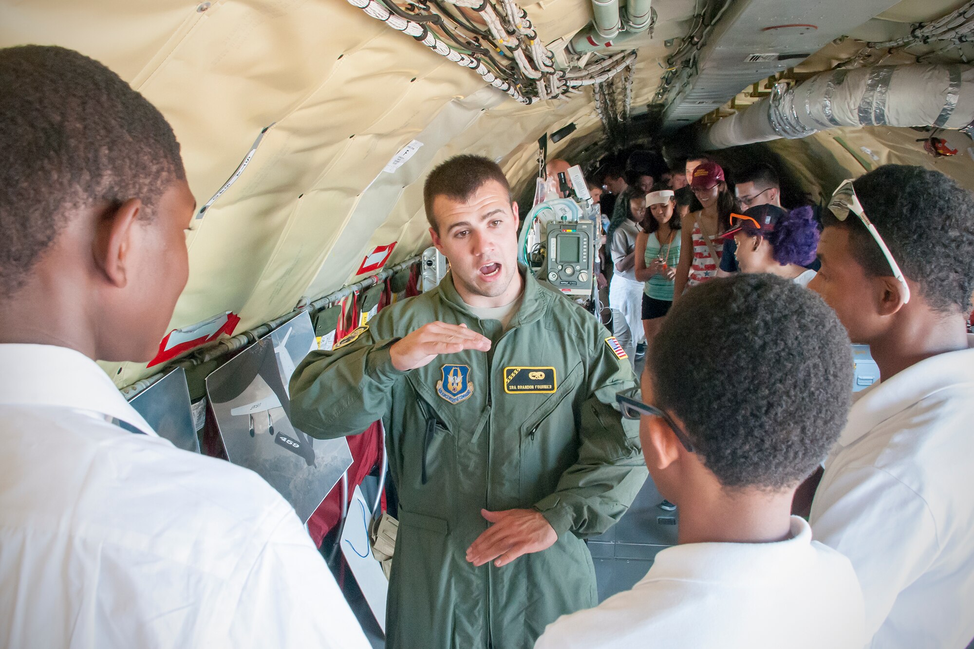 Senior Airman Brandon Fournier, 459th Maintenance Group crew chief, talks about the inflight refueling capabilities of the KC-135R Sratotanker to a group of students at the Joint Base Andrews Air Show Sept. 18, 2015. The 459th Airlift Wing provided tours of the aircraft and illustrated medical and refueling capabilities to the public during the open house. (U.S. Air Force photo/Staff Sgt. Kat Justen)