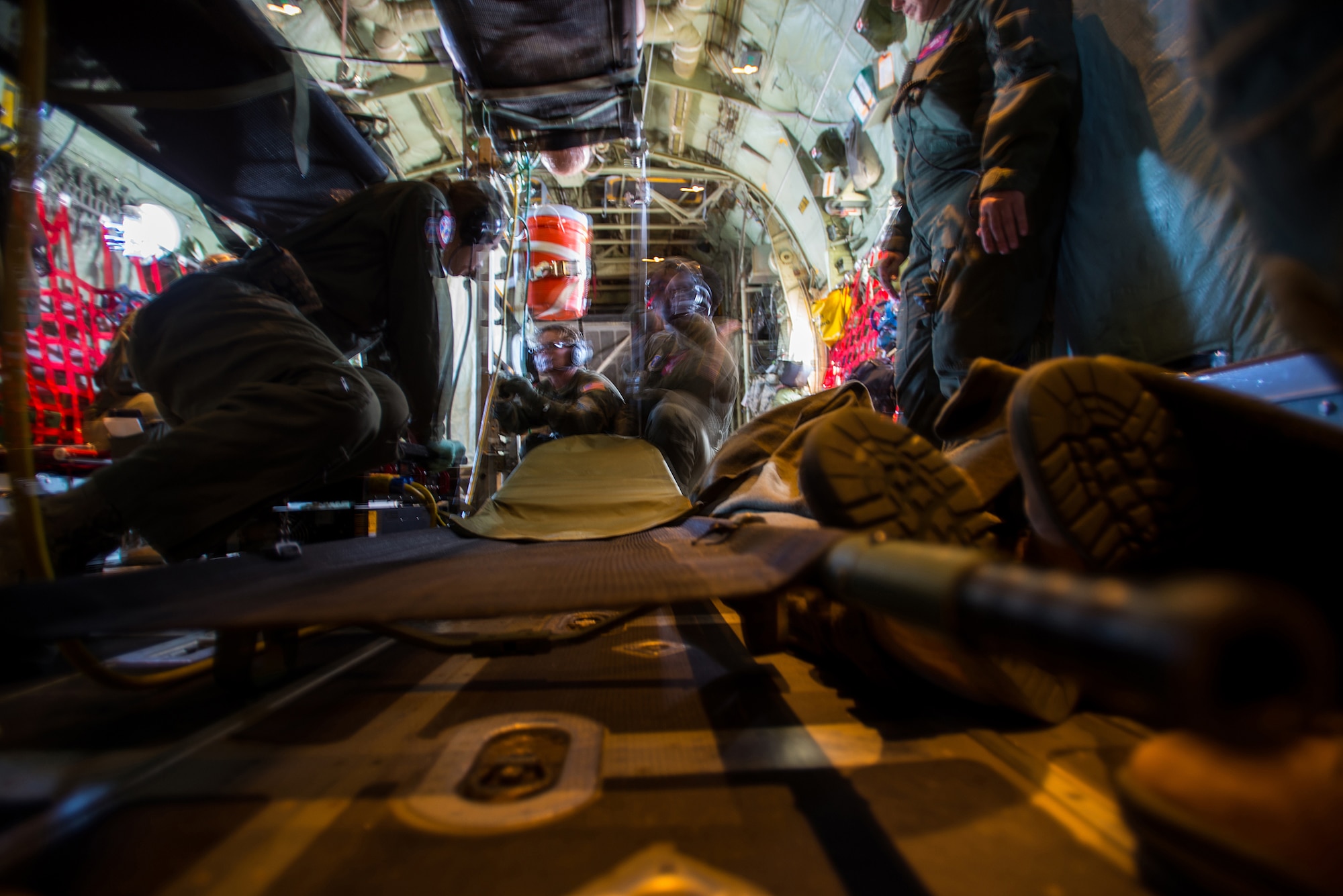Members of the 137th Aeromedical Evacuation Squadron prepare a litter for a simulated patient during an in-flight training scenario on a C-130 Hercules flown by the 130th Airlift Wing, West Virginia ANG, as part of a joint ANG training mission, Sep. 12, 2015. The training helped 137 AES Airmen experience different airframes and new flight crews while maintaining flight readiness. (U.S. Air National Guard photo by Senior Airman Tyler Woodward/Released)