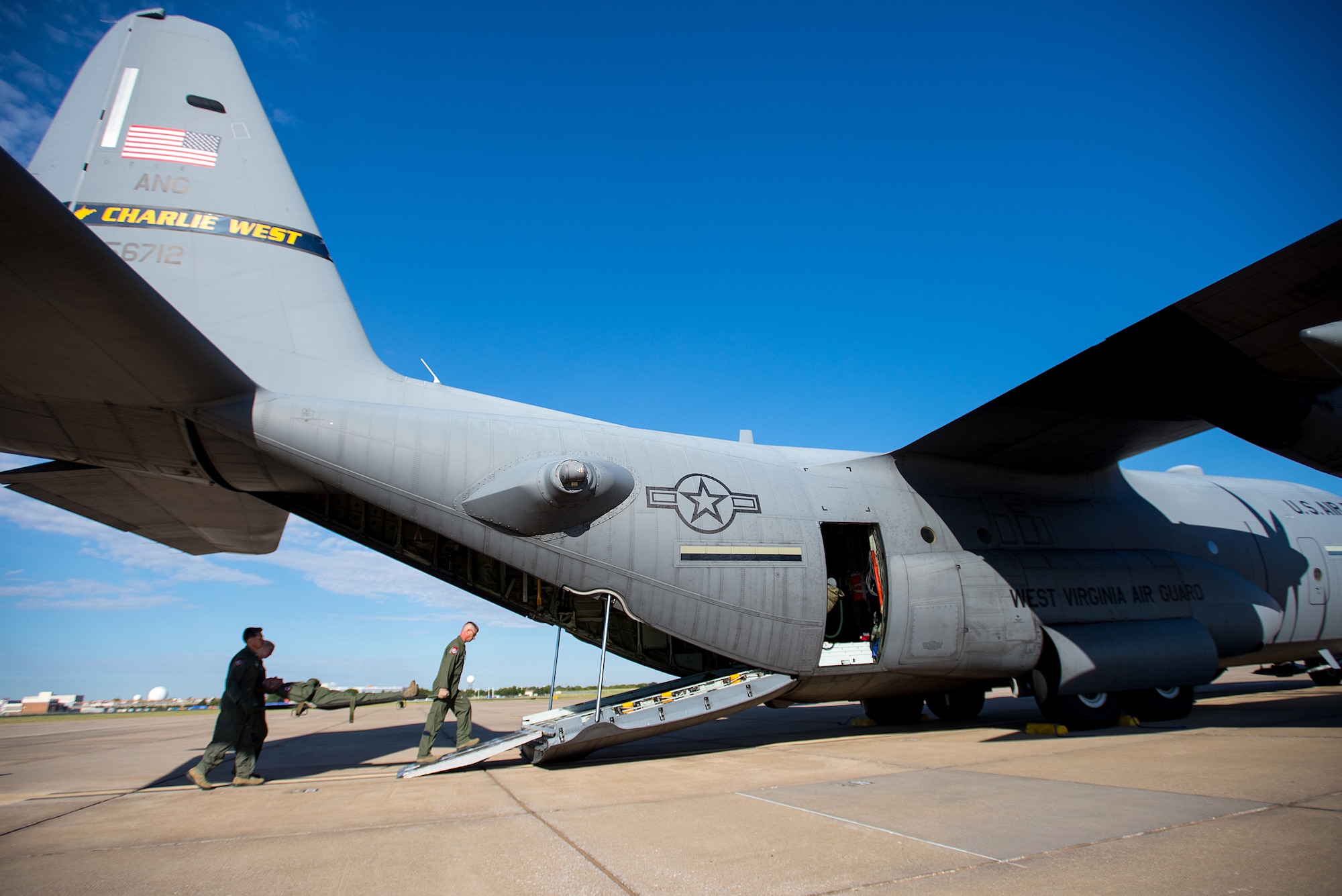 Airmen of 137th Aeromedical Evacuation Squadron, Oklahoma Air National Guard, load medical supplies and simulated patients onto a C-130 Hercules flown by the 130th Airlift Wing, West Virginia ANG, as part of a joint ANG training mission, Sep. 12, 2015. The training helped 137 AES Airmen experience different airframes and new flight crews while maintaining flight readiness. (U.S. Air National Guard photo by Senior Airman Tyler Woodward/Released)