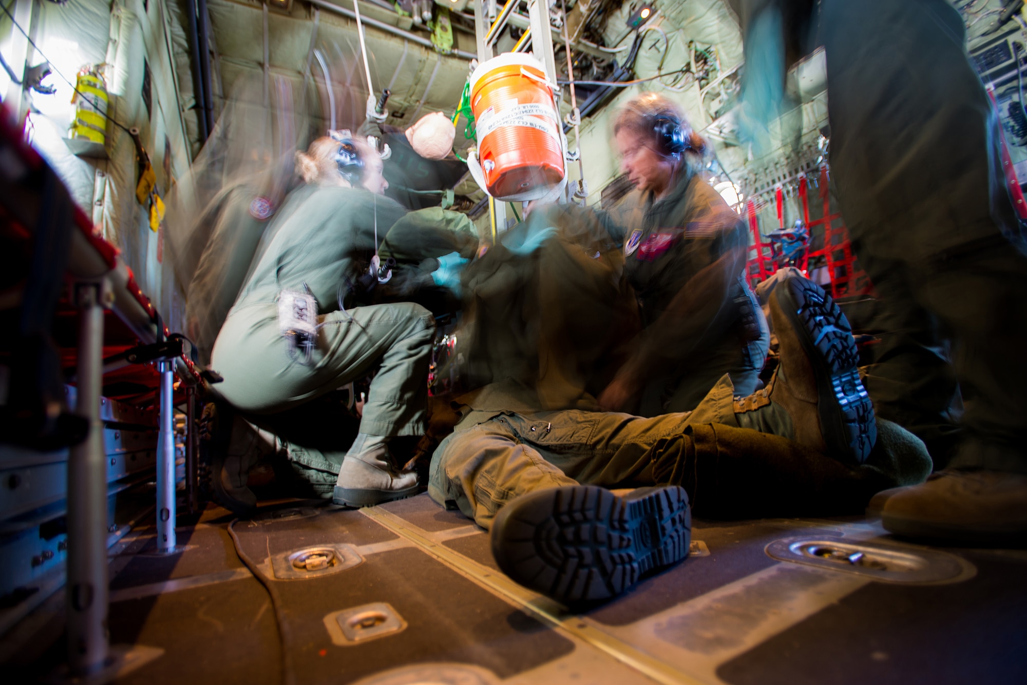 Airmen of the 137th Aeromedical Evacuation Squadron, Oklahoma Air National Guard, treat a simulated injured patient while on a C-130 Hercules flown by the 130th Airlift Wing, West Virginia ANG, as part of a joint ANG training mission, Sep. 12, 2015. The training helped 137 AES Airmen experience different airframes and new flight crews while maintaining flight readiness.(U.S. Air National Guard photo by Senior Airman Tyler Woodward/Released) 