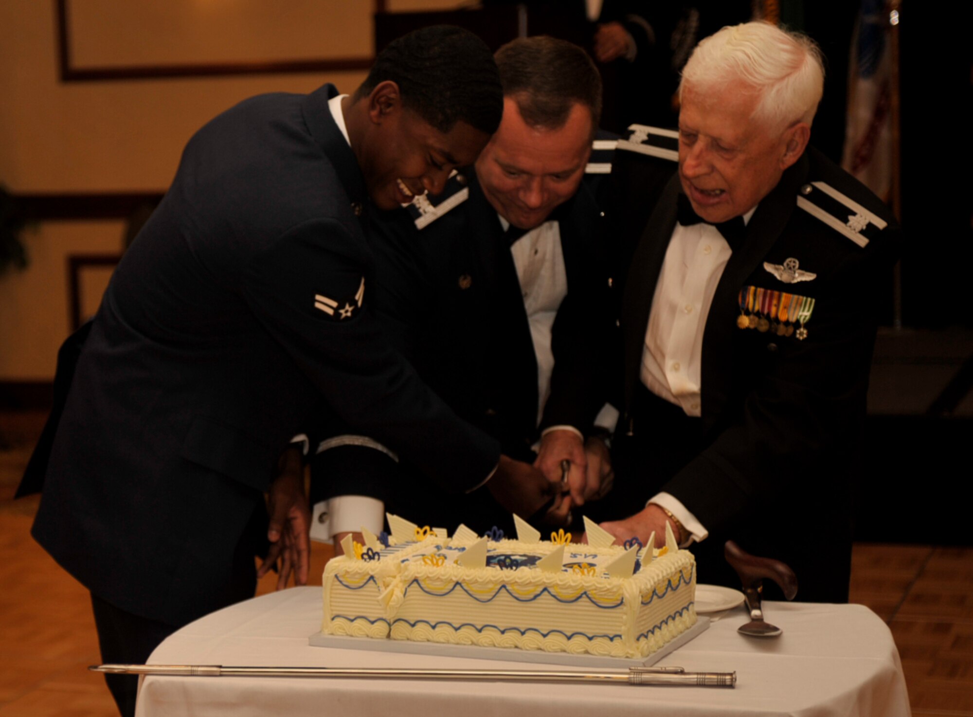 (L-R) Airman 1st Class Aaron Oden, 92nd Air Refueling Wing administrative apprentice, Col. Brian McDaniel, 92nd Air Refueling Wing Commander, and Retired Lt. Col. George Swagel cut the cake during the Air Force Ball Sept. 18, 2015, at Spokane Wash. Oden was the youngest Airman at the event and Swagel was the oldest.  Fairchild Air Force Base members celebrated the 68th birthday of the U.S. Air Force.