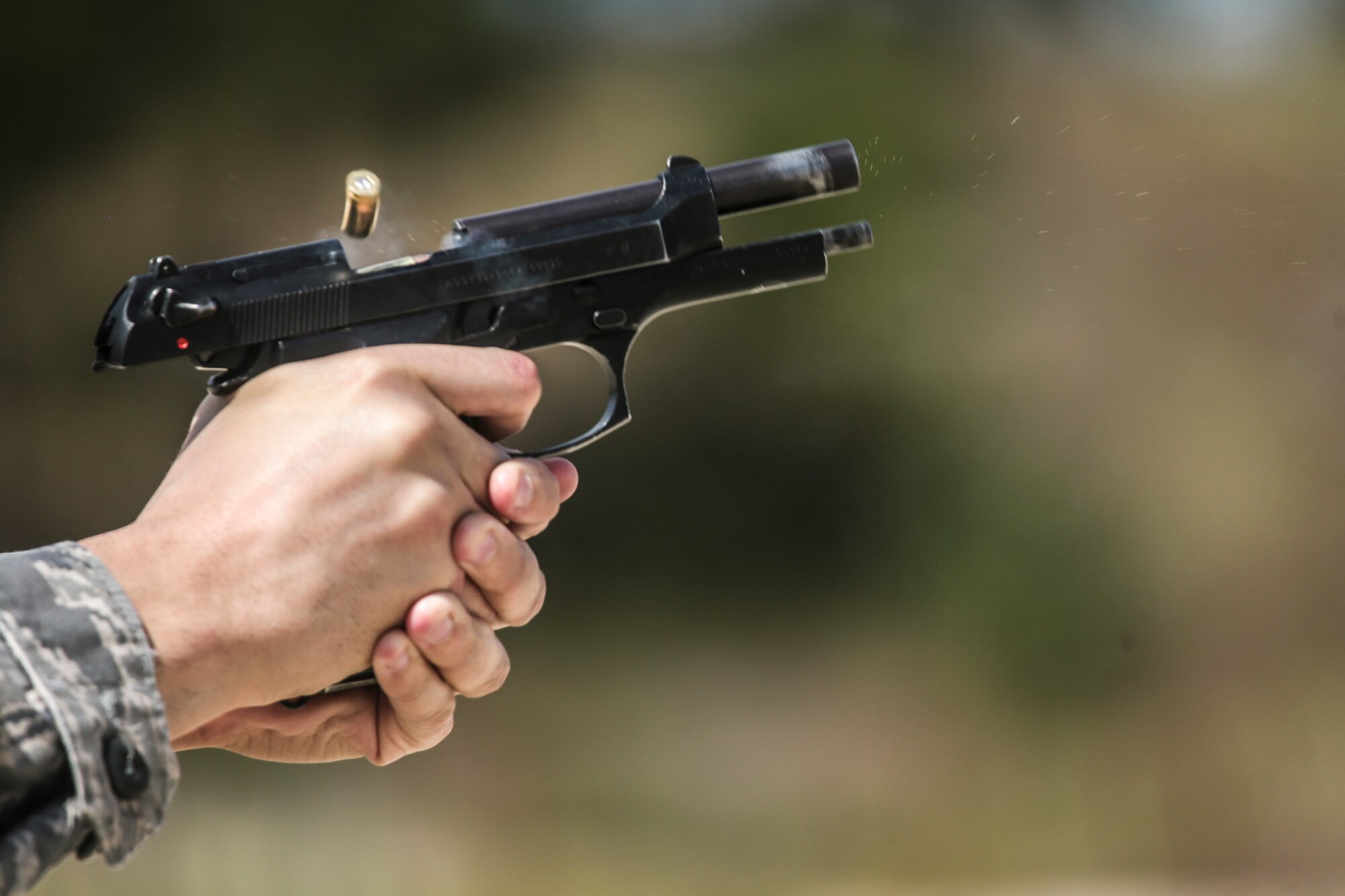 U.S. Air Force Staff Sgt. Demetrius Reyes from the New Jersey Air National Guard's 150th Special Operations Squadron fires the M9 pistol during qualification firing at Joint Base McGuire-Dix-Lakehurst, N.J., Sept. 19, 2015. (U.S. Air National Guard photo by Tech. Sgt. Matt Hecht/Released)