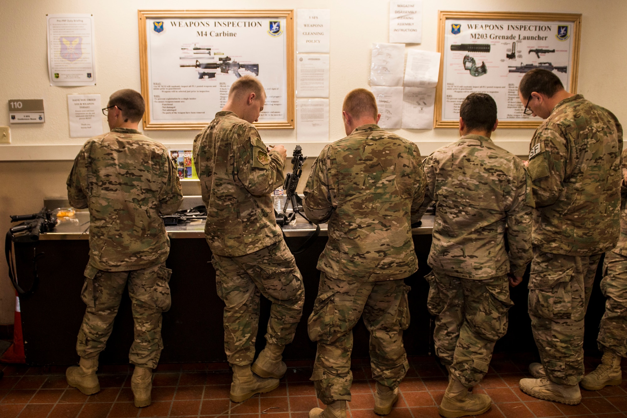Airmen from the 791st Security Forces Squadron clean their weapons at the 5th Security Forces Armory at Minot Air Force Base, N.D., September 18, 2015. If weapons systems are not cleaned regularly, dirt, sand or carbon buildup may keep the magazine from feeding or cause the weapon to malfunction. (U.S. Air Force photo/ Airman 1st Class Justin T. Armstrong)