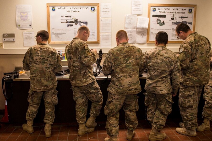 Airmen from the 791st Security Forces Squadron clean their weapons at the 5th Security Forces Armory at Minot Air Force Base, N.D., September 18, 2015. If weapons systems are not cleaned regularly, dirt, sand or carbon buildup may keep the magazine from feeding or cause the weapon to malfunction. (U.S. Air Force photo/ Airman 1st Class Justin T. Armstrong)