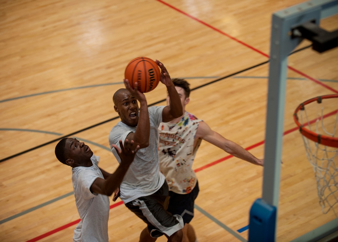 U.S. Air Force Tech. Sgt. Omar Thompson, 317th Maintenance Squadron warrior week participant, throws a basketball Aug. 25, 2015, at Dyess Air Force Base, Texas. Airmen competed in tournaments during the Dyess Warrior Week to build morale and earn a Comprehensive Airman Fitness credit. (U.S. Air Force photo by Airman Quay Drawdy/Released)