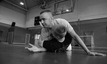 U.S. Air Force Master Sgt. Mark Tilsher, left, 86th Force Support Squadron Airman Leadership School commandant and director of Kaiserslautern Military Community Gracie Defense System, Ramstein Air Base, Germany, explains step-by-step techniques on how to escape from an assailant with U.S. Air Force Staff Sgt. Matthew McConnell, 83rd Network Operations Squadron Detachment 4 plans and integration NCO and deputy director of KMCGDS, Ramstein Air Base, Germany, Sept. 15, 2015, at the Northside Fitness Center on RAF Mildenhall, England. After each demonstration, students were given the opportunity to apply what they learned. (U.S. Air Force photo by Staff Sgt. Micaiah Anthony/Released)