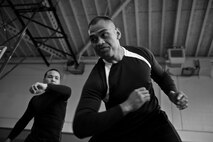 Students of the Gracie Defense System seminar practice evasive maneuvers at the Northside Fitness Center Sept. 15, 2015, on RAF Mildenhall, England. Students are given the opportunity to practice what they learned after the instructors perform their demonstration. (U.S. Air Force photo by Staff Sgt. Micaiah Anthony/Released)  