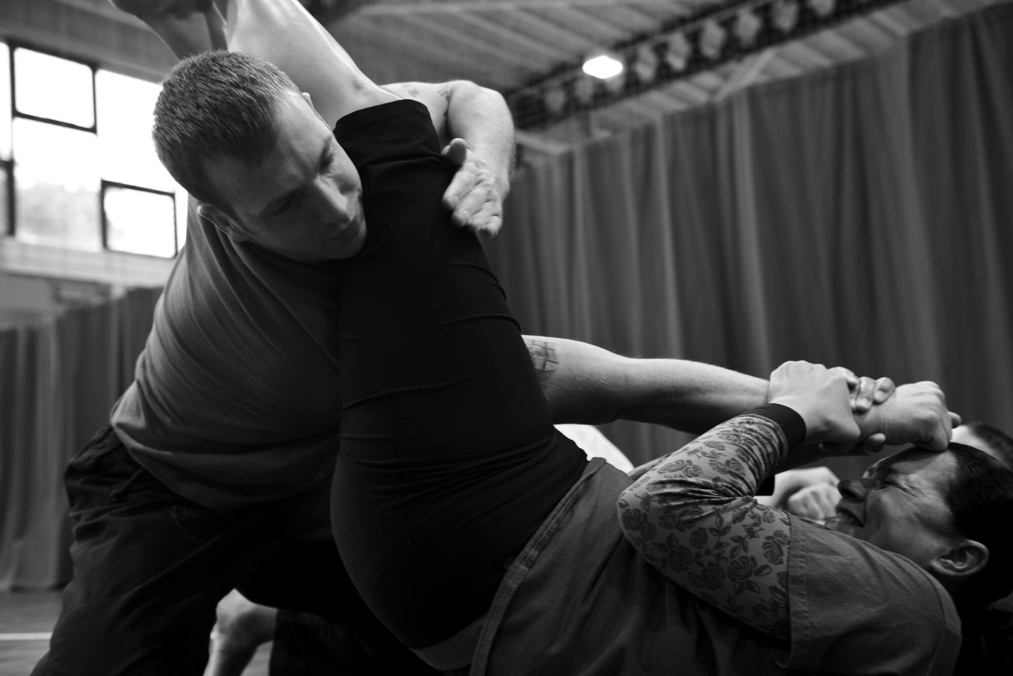 A Gracie Defense Systems student puts U.S. Air Force Staff Sgt. Saul Grosshuesch, 100th Maintenance Squadron unit deployment manager, in an arm bar during a self-defense class Sept. 18, 2015, at the Northside Fitness Center on RAF Mildenhall, England. Grosshuesch learned about the Gracie Defense System seminars conducted out of Ramstein Air Base, Germany, and arranged for the class to be taught on RAF Mildenhall. (U.S. Air Force photo by Staff Sgt. Micaiah Anthony/Released)