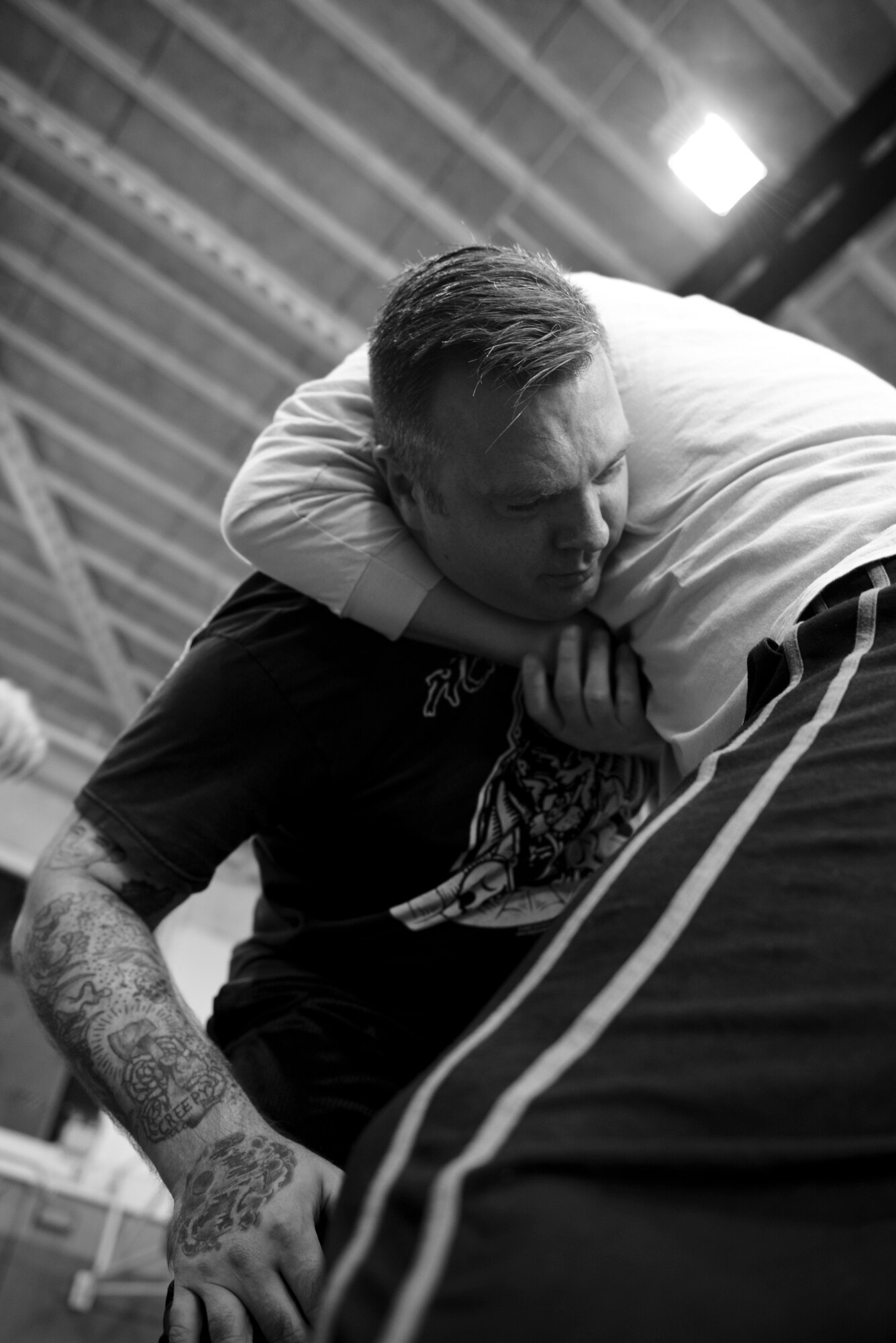 A student of the Gracie Defense System seminar places another student in a guillotine choke hold Sept. 17, 2015, at the Northside Fitness Center on RAF Mildenhall, England. The students were taught the choke hold in the event an attacker charges at them. If applied correctly the maneuver can knock the assailant out in a few seconds. (U.S. Air Force photo by Staff Sgt. Micaiah Anthony/Released)  