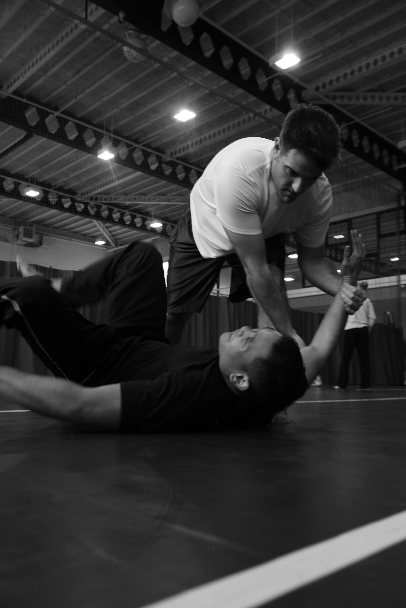 A student of the Gracie Defense System seminar throws another student after escaping a choke hold Sept. 17, 2015, at the Northside Fitness Center on RAF Mildenhall, England. Students took turns being the assailant and the target to ensure they both had an opportunity to hone their techniques. (U.S. Air Force photo by Staff Sgt. Micaiah Anthony/Released)  