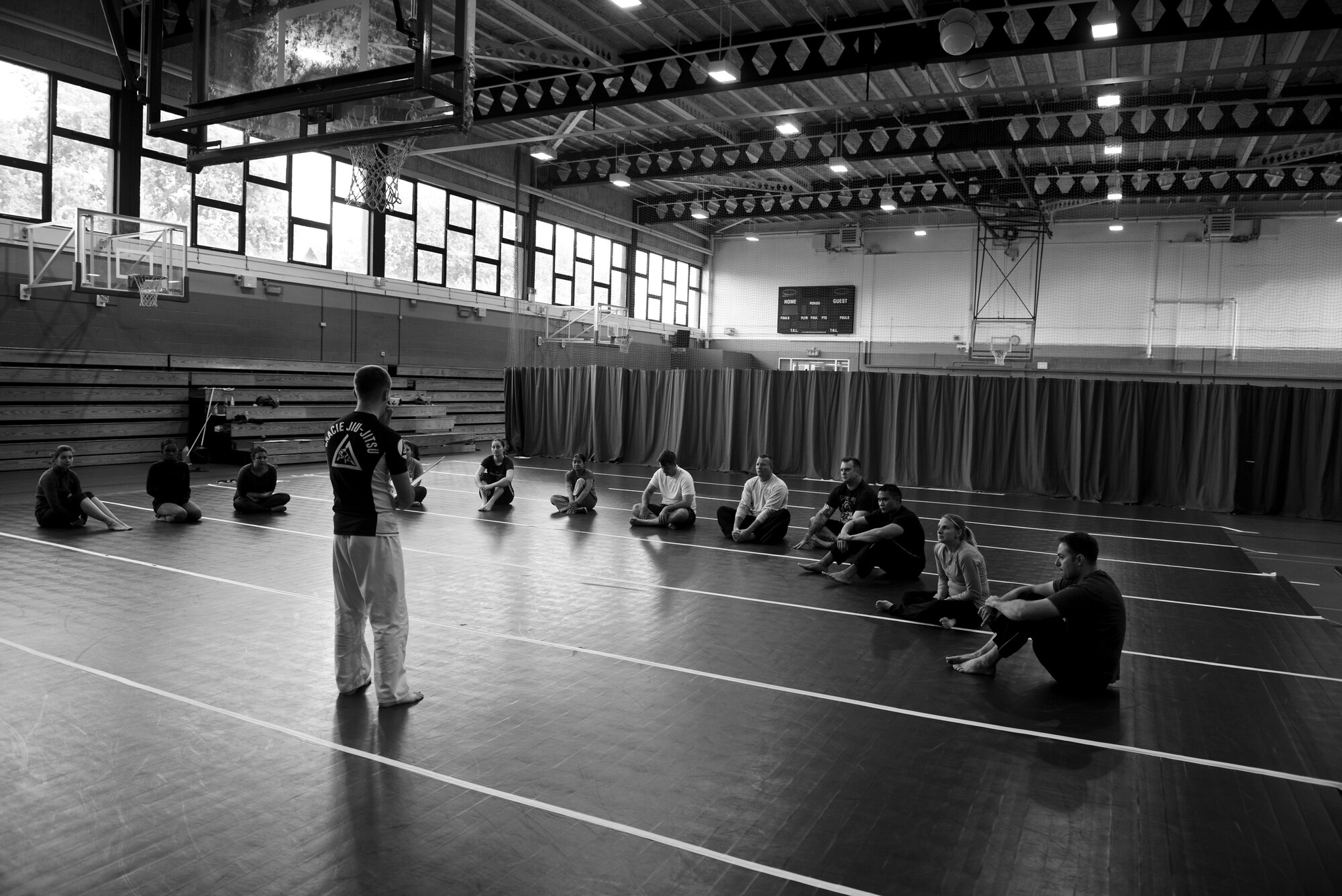 U.S. Air Force Staff Sgt. Matthew McConnell, 83rd Network Operations Squadron Detachment 4 plans and integration NCO and deputy director of Kaiserslautern Military Community Gracie Defense System, Ramstein Air Base, Germany, briefs a self-defense class Sept. 17, 2015, at the Northside Fitness Center on RAF Mildenhall, England. Gracie self defense instructors from Ramstein Air Base, Germany and Spangdahlem Air Base, Germany came to RAF Mildenhall to teach a week long self-defense seminar. (U.S. Air Force photo by Staff Sgt. Micaiah Anthony/Released)  