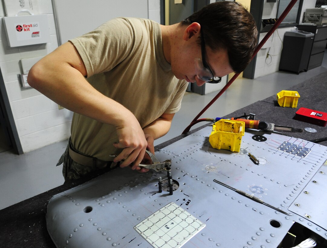 U.S. Air Force Airman 1st Class Logan Gutierrez, 509th Maintenance Squadron low observable trainee, performs a flush repair on an aircraft part at Whiteman Air Force Base, Mo., Sept. 15, 2015. Flush repairs are done to restore punctures on aircraft parts, preventing the metal from loosening or corroding. (U.S. Air Force photo by Senior Airman Keenan Berry/Released)

