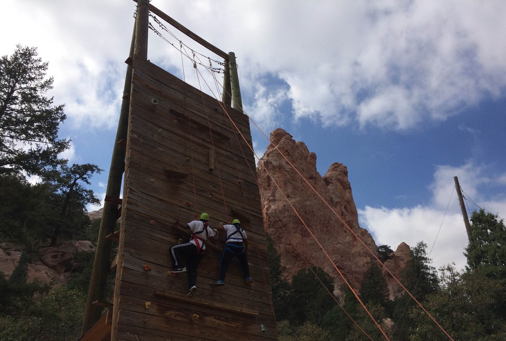 PETERSON AIR FORCE BASE, Colo. – Staff Sgt. Thurmann Minor, 544th Intelligence Surveillance and Reconnaissance Group, and his wife Staff Sgt. Danielle Minor, 21st Medical Support Squadron, climb a wall during a one day resiliency retreat Sept. 11, 2015 at Glen Eyrie Conference Center in downtown Colorado Springs. The retreat was designed to help military-to-military couples focus on their relationship and strengthen communication. (courtesy photo)