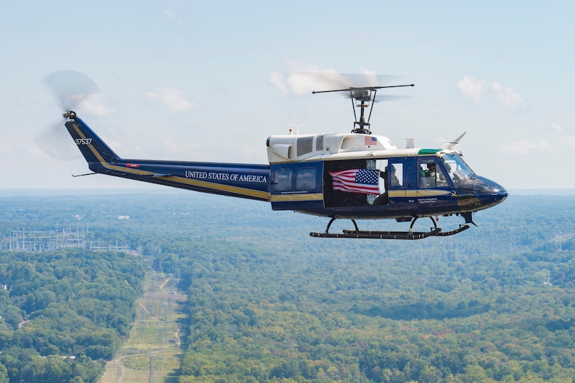 A UH-1N Iroquois flies an American Flag during the 2015 Joint Base Andrews Air Show, Sept. 19. The helicopter is currently assigned to the 1st Helicopter Squadron at JBA. (U.S. Air Force photo/Airman 1st Class Ryan J. Sonnier/Released)