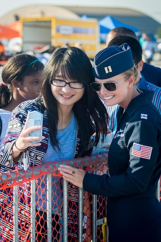 Xinzhe Zhou, air show spectator, and Capt. Sara Harper, U.S. Air Force Thunderbirds Public Affairs officer, take a selfie after a performance during the 2015 Joint Base Andrews Air Show, Sept. 19. The Thunderbirds were the headlining act for the event. (U.S. Air Force photo/Airman 1st Class Ryan J. Sonnier/Released)