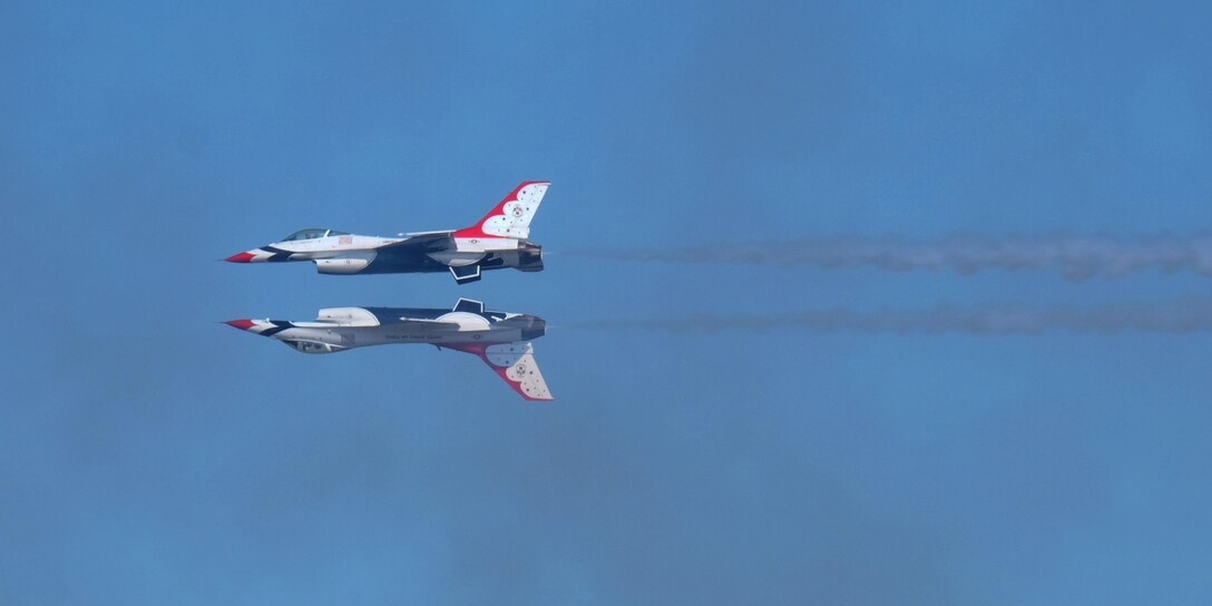 U.S. Air Force Thunderbirds perform a mirror image maneuver at the 2015 Joint Base Andrews Air Show Sept. 19, 2015. For 62 years, the Thunderbirds have represented the epitome of Air Force precision and dedication. (U.S. Air Force photos by Senior Airman Preston Webb/RELEASED)