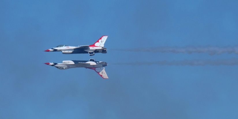 U.S. Air Force Thunderbirds perform a mirror image maneuver at the 2015 Joint Base Andrews Air Show Sept. 19, 2015. For 62 years, the Thunderbirds have represented the epitome of Air Force precision and dedication. (U.S. Air Force photos by Senior Airman Preston Webb/RELEASED)