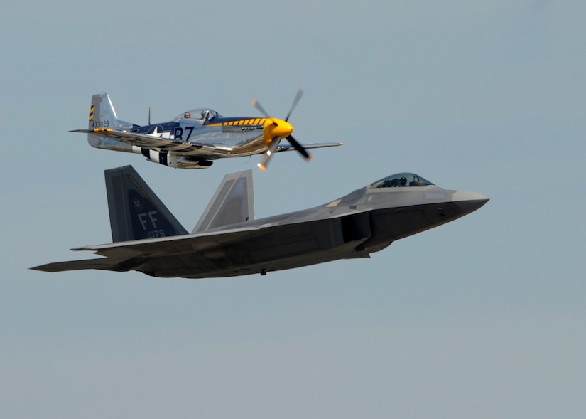 A P-51 Mustang and an F-22 Raptor perform a heritage flight at the 2015 Joint Base Andrews Air Show Sept. 19, 2015. These aircraft represent more than half a century of U.S. Air Force history. (U.S. Air Force photos by Senior Airman Preston Webb/RELEASED)