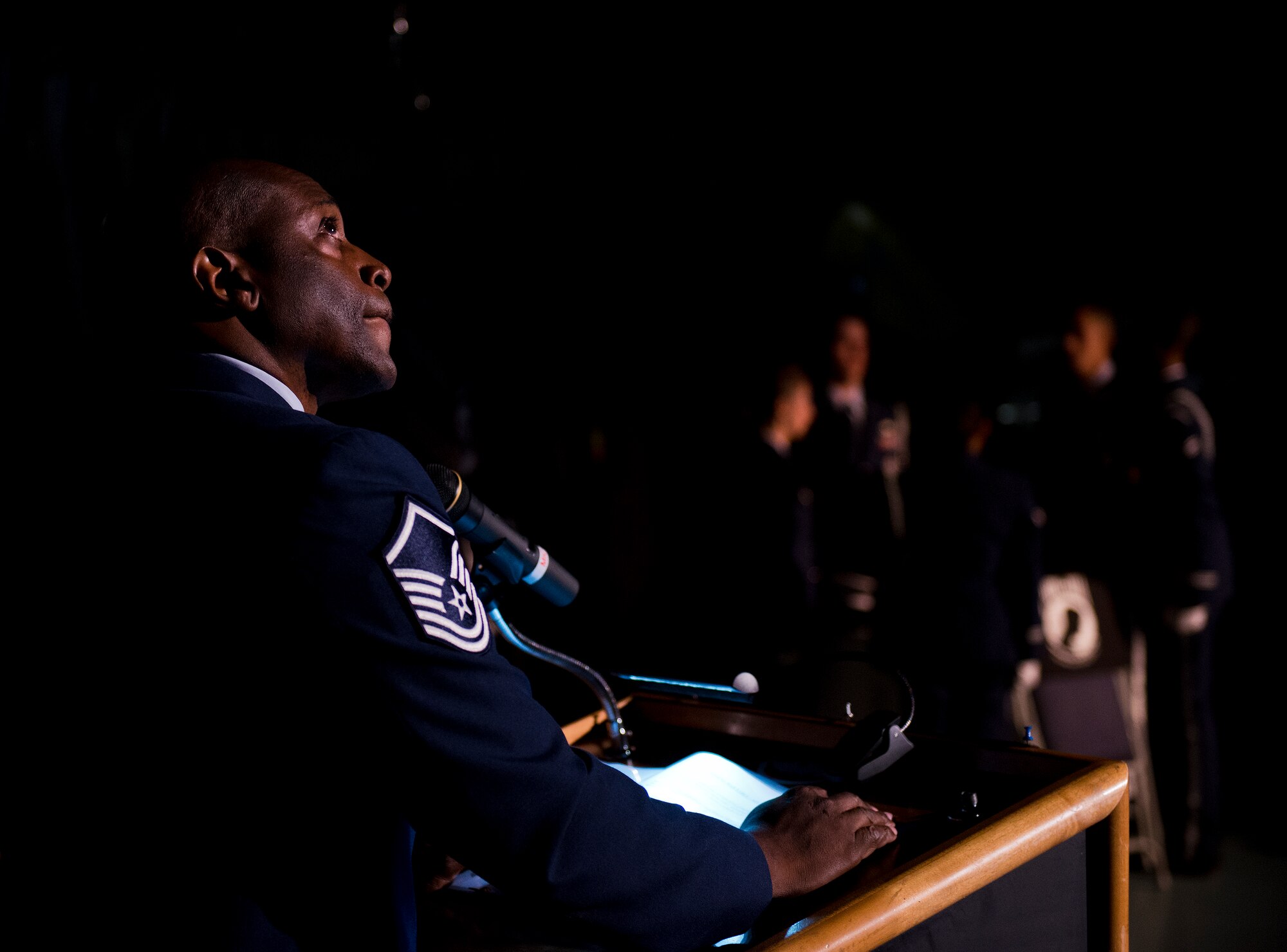 Retired Master Sgt. Allen Ajaye listens for the bell toll during the POW/MIA table presentation at the remembrance ceremony Sept. 18 Eglin Air Force Base, Fla.  The ceremony paid tribute to those military members who have yet to return home from defending America. The event featured tributes, guest speakers and honor guard procedures. (U.S. Air Force photo/Samuel King Jr.)
