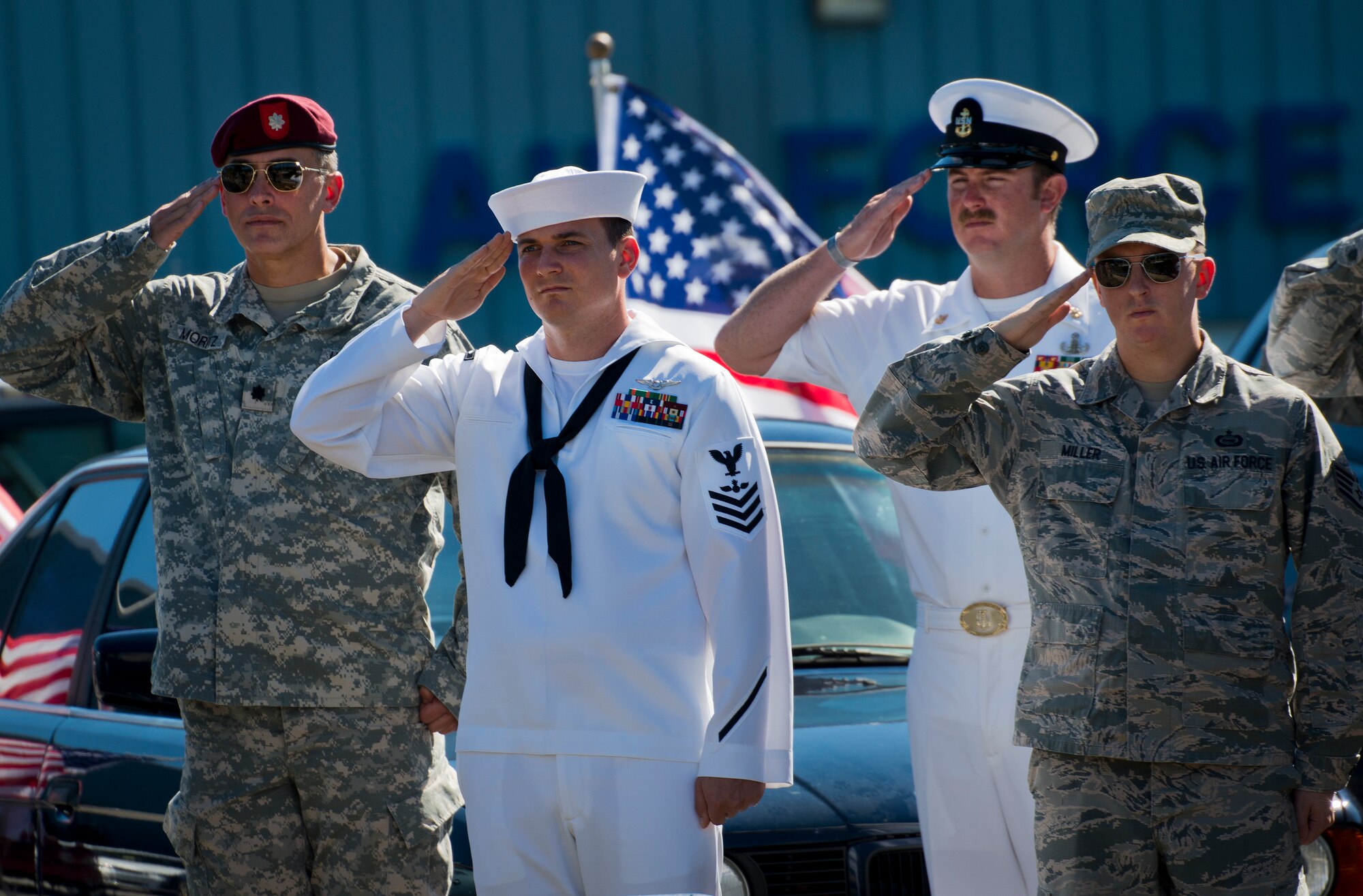 Military members salute as Taps plays at the POW/MIA remembrance ceremony Sept. 18 at the Air Force Armament Museum.  The ceremony paid tribute to those military members who have yet to return home from defending America. The event featured tributes, guest speakers and honor guard procedures. (U.S. Air Force photo/Samuel King Jr.)