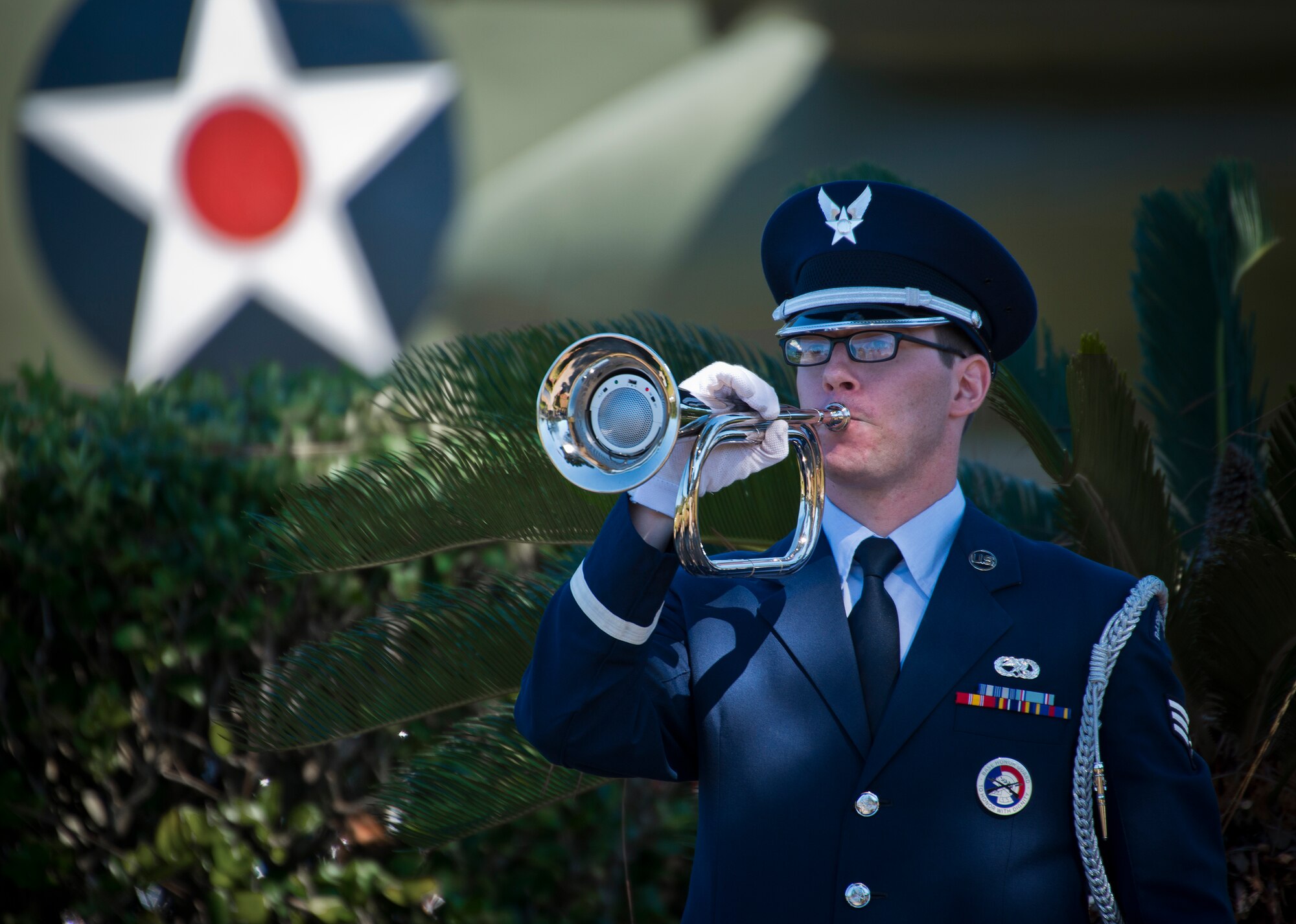 Senior Airman Aaron Deforge, Eglin Air Force Base honor guard, plays Taps at the POW/MIA remembrance ceremony Sept. 18 at the Air Force Armament Museum.  The ceremony paid tribute to those military members who have yet to return home from defending America. The event featured tributes, guest speakers and honor guard procedures. (U.S. Air Force photo/Samuel King Jr.)
