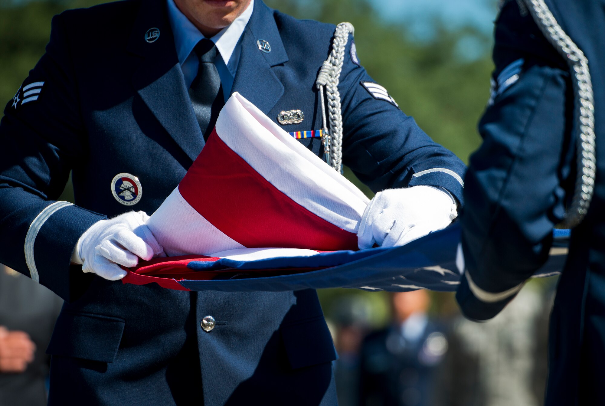Senior Airman Brandon Pecsi, Eglin Air Force Base honor guard, performs a flag folding demonstration at the POW/MIA remembrance ceremony Sept. 18 at the Air Force Armament Museum.  The ceremony paid tribute to those military members who have yet to return home from defending America. The event featured tributes, guest speakers and honor guard procedures. (U.S. Air Force photo/Samuel King Jr.)