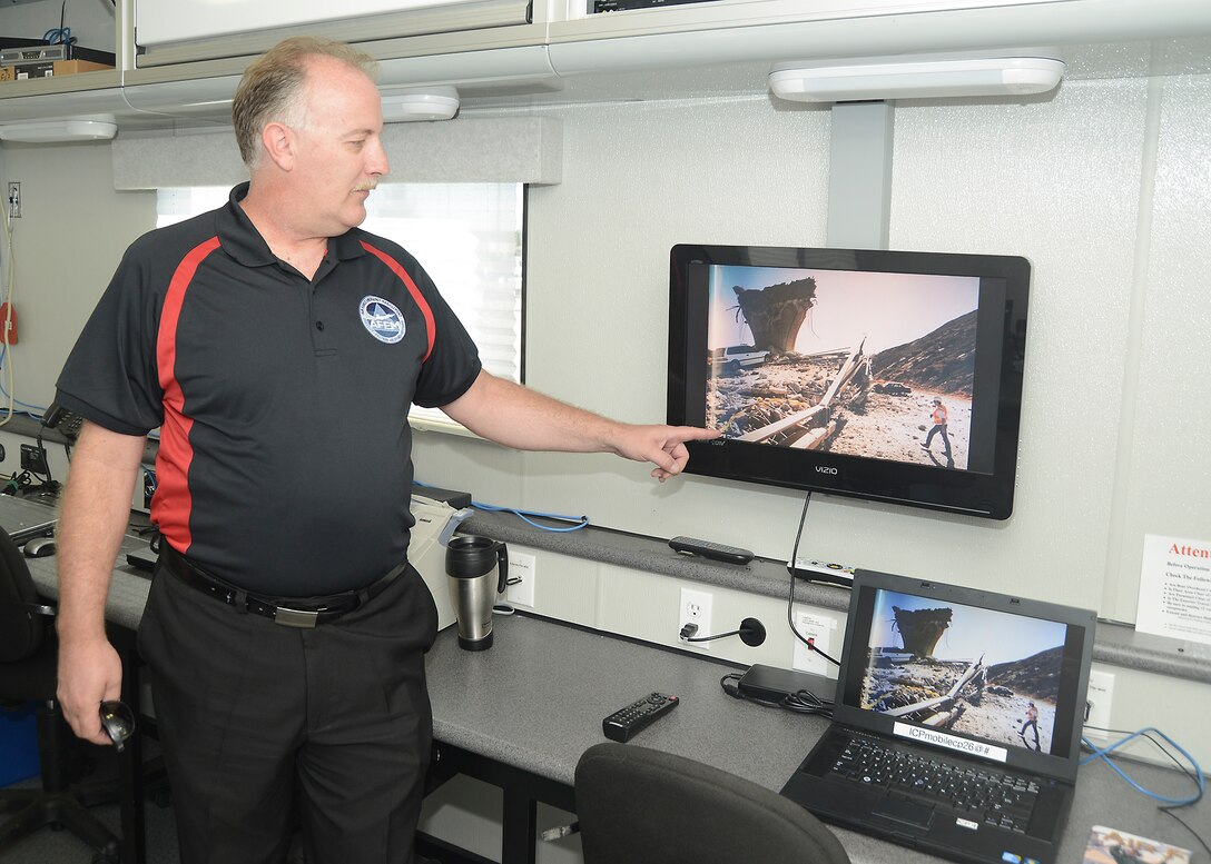 Michael Feyerle, 812th Civil Engineering Squadron, Edwards AFB Emergency Management chief, points to an educational video about earthquake preparedness inside the base's mobile Incident Command Post Sept. 16. The ICP along with an earthquake simulator were brought to the Exchange parking lot to educate the Edwards community during National Preparedness Month. (U.S. Air Force photo by Kenji Thuloweit)