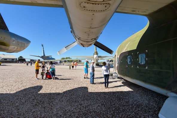 Attendees look at a C-123 Provider aircraft during the Wings and Wheels Car Show and Food for Life event at the Hill Aerospace Museum, Sept. 19, 2015. Many aircraft were opened to for the events. While the events were free, attendees were encouraged to donate non-perishable food items that will replenish the Hill Air Force Base Airman's Attic food pantry. (U.S. Air Force photo by R. Nial Bradshaw)