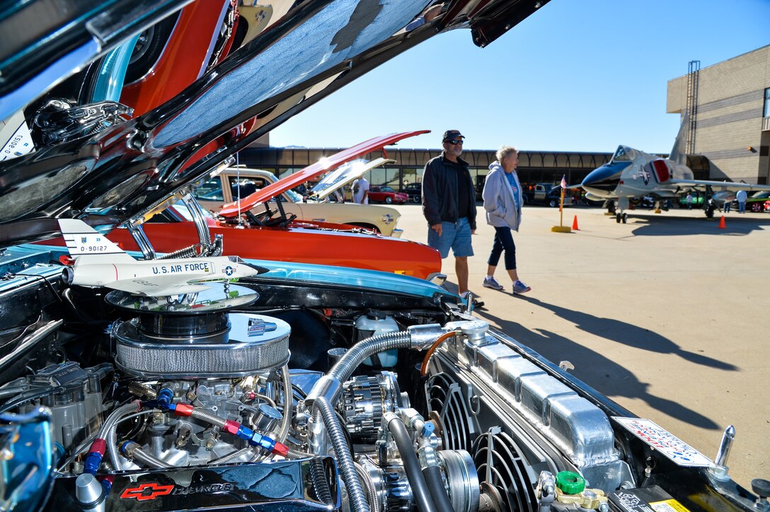 A model F-106 Delta Dart aircraft sits atop the air cleaner of a 1966 Chevy Chevelle during the Wings and Wheels Car Show at Hill Aerospace Museum, Sept. 19, 2015. All car show entrants were given an opportunity to have their vehicle photographed in front of the Hill Aerospace Museum's F-106 Delta Dart, sitting in the photo’s background. (U.S. Air Force photo by R. Nial Bradshaw)