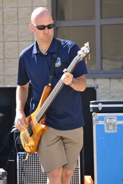 U.S. Air Force Tech. Sgt. Scott M. Filipek, regional band specialist with the 566th Air Force Band, Illinois Air National Guard, performs with the unit’s rock band ensemble during Wingman and Family Day at the 182nd Airlift Wing, Peoria, Ill., Sept. 12, 2015. The event was organized to promote resiliency in Airmen and their friends and family. (U.S. Air National Guard photo by Staff Sgt. Lealan Buehrer/Released)