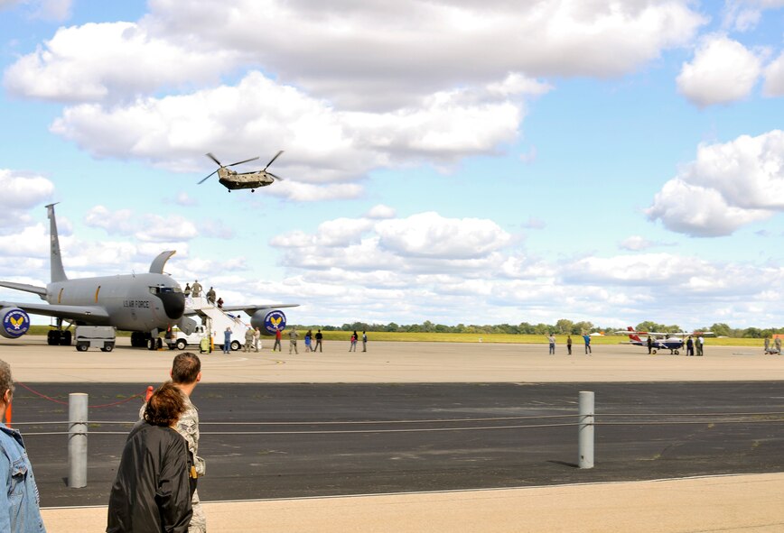 A U.S. Army CH-47 Chinook helicopter with the Illinois Army National Guard flies over Wingman and Family Day at the 182nd Airlift Wing, Peoria, Ill., Sept. 12, 2015. The wingman and family day was organized to promote resiliency in Airmen and their friends and family. (U.S. Air National Guard photo by Staff Sgt. Lealan Buehrer/Released)